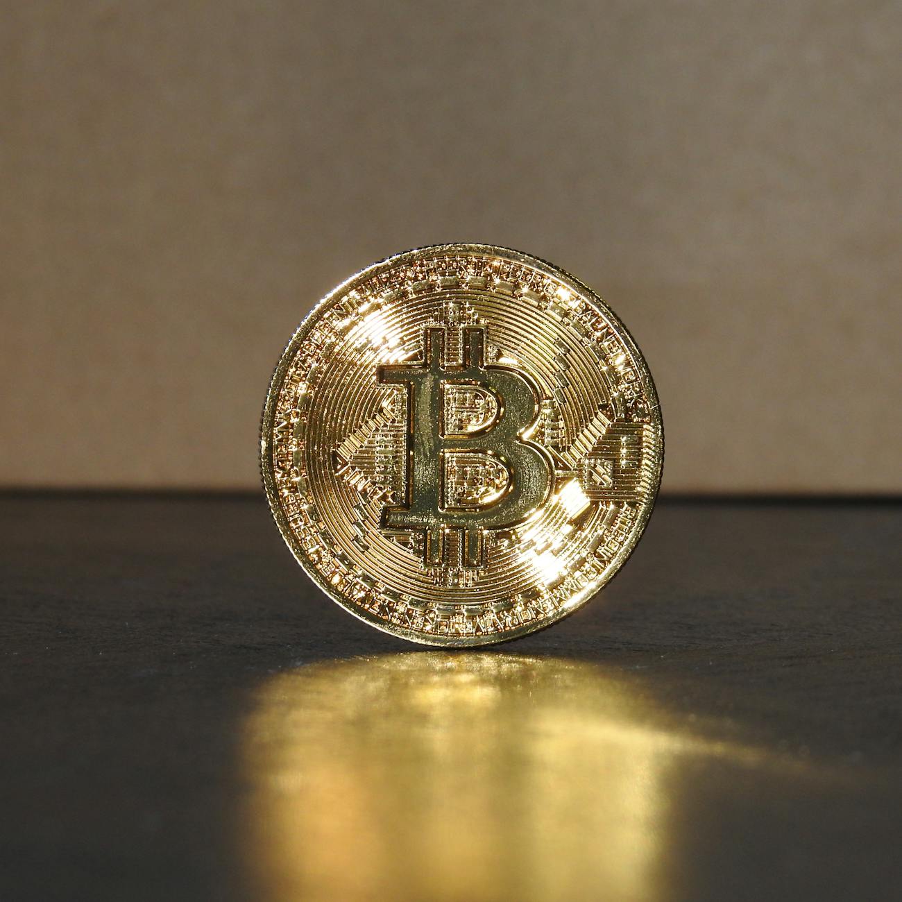 Bitcoin logo with a person's hand holding it, suggesting a connection to the CIA.